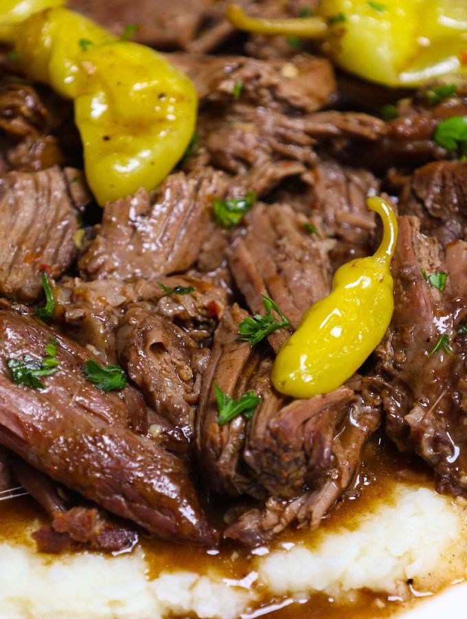 Ultimate Crockpot Mississippi Roast is amazingly juicy and fork-tender! It takes 10 minutes of prep in the morning and the roast is simmered in a rich and divine sauce all day in the slow cooker. Add some vegetables to the crockpot and you’ll have a perfect weeknight meal with build-in gravy. #MississippiRoast #MississippiPotRoast #SlowCookerMississippiPotRoast #CrockpotMississippiRoast