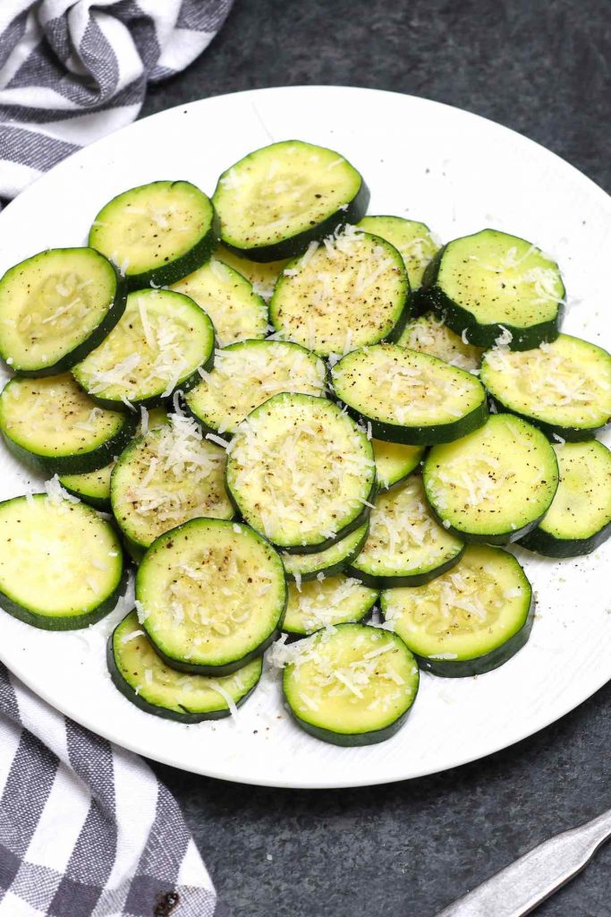 Sous vide zucchini on a white plate.