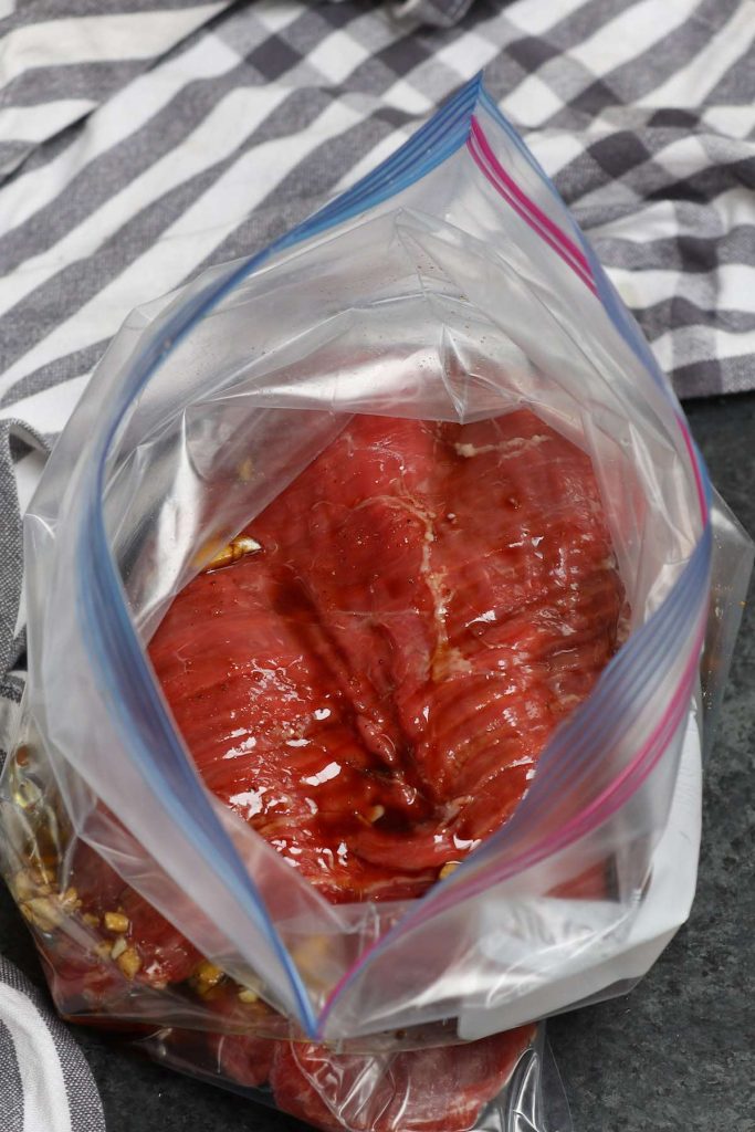 Marinating flank steak in a zip-top bag.