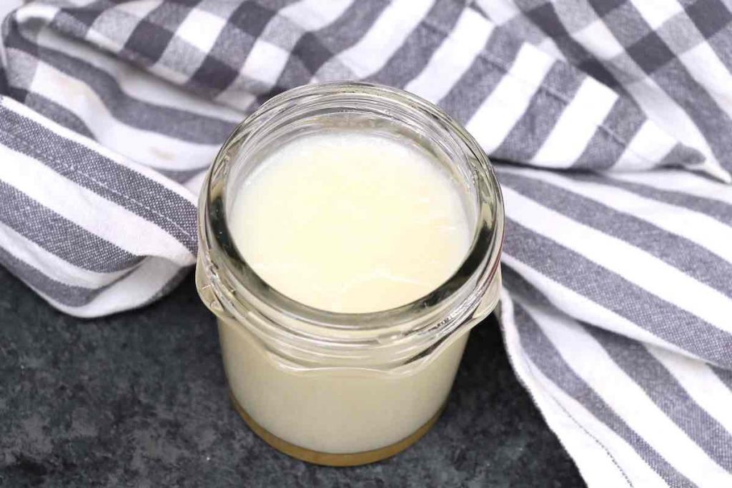 Beef tallow in solid form in a jar.
