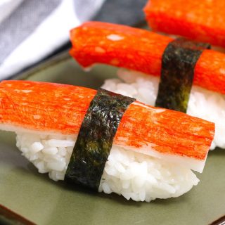 Kanikama nigiri rolls on a Japanese plate.