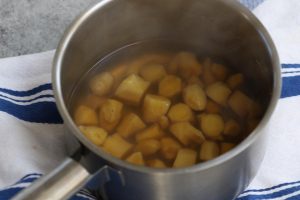 Simmering ginger in the saucepan.