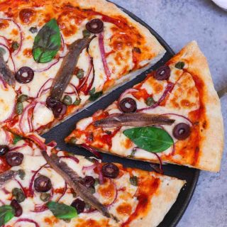 This Anchovy Pizza begins with a homemade pizza dough, topped with cured anchovies, olives, capers, onions, and mozzarella cheese. With a few tips, you’ll learn how to make a perfect anchovy pizza at home.