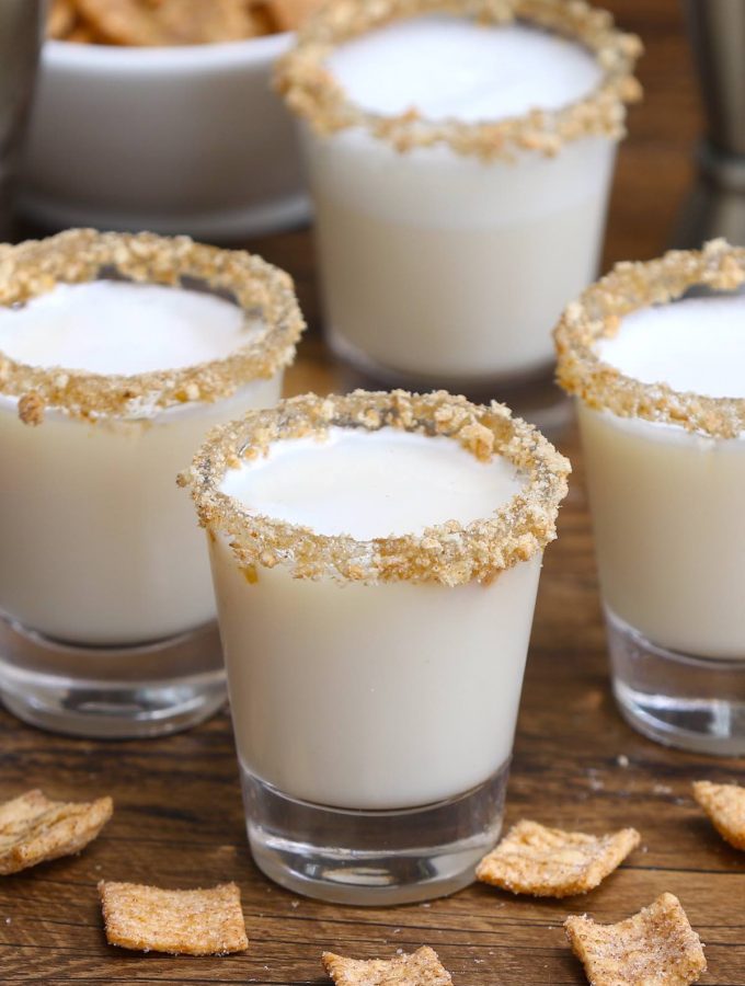 Cinnamon Toast Crunch Shot is an adult version of your favorite childhood cereal, in shot form. The base of this delicious alcoholic drink is RumChata and Fireball Whiskey, served in shot glasses rimmed with crushed cinnamon toast cereal. Sweet, boozy, and creamy with a nice cinnamon flavor! #CinnamonToastCrunchShot #CinnamonToastShot #RumChataShot
