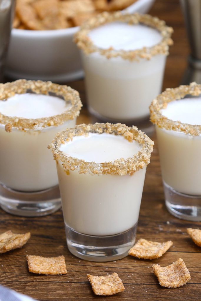 Cinnamon Toast Crunch Shot is an adult version of your favorite childhood cereal, in shot form. The base of this delicious alcoholic drink is RumChata and Fireball Whiskey, served in shot glasses rimmed with crushed cinnamon toast cereal. Sweet, boozy, and creamy with a nice cinnamon flavor! #CinnamonToastCrunchShot #CinnamonToastShot #RumChataShot