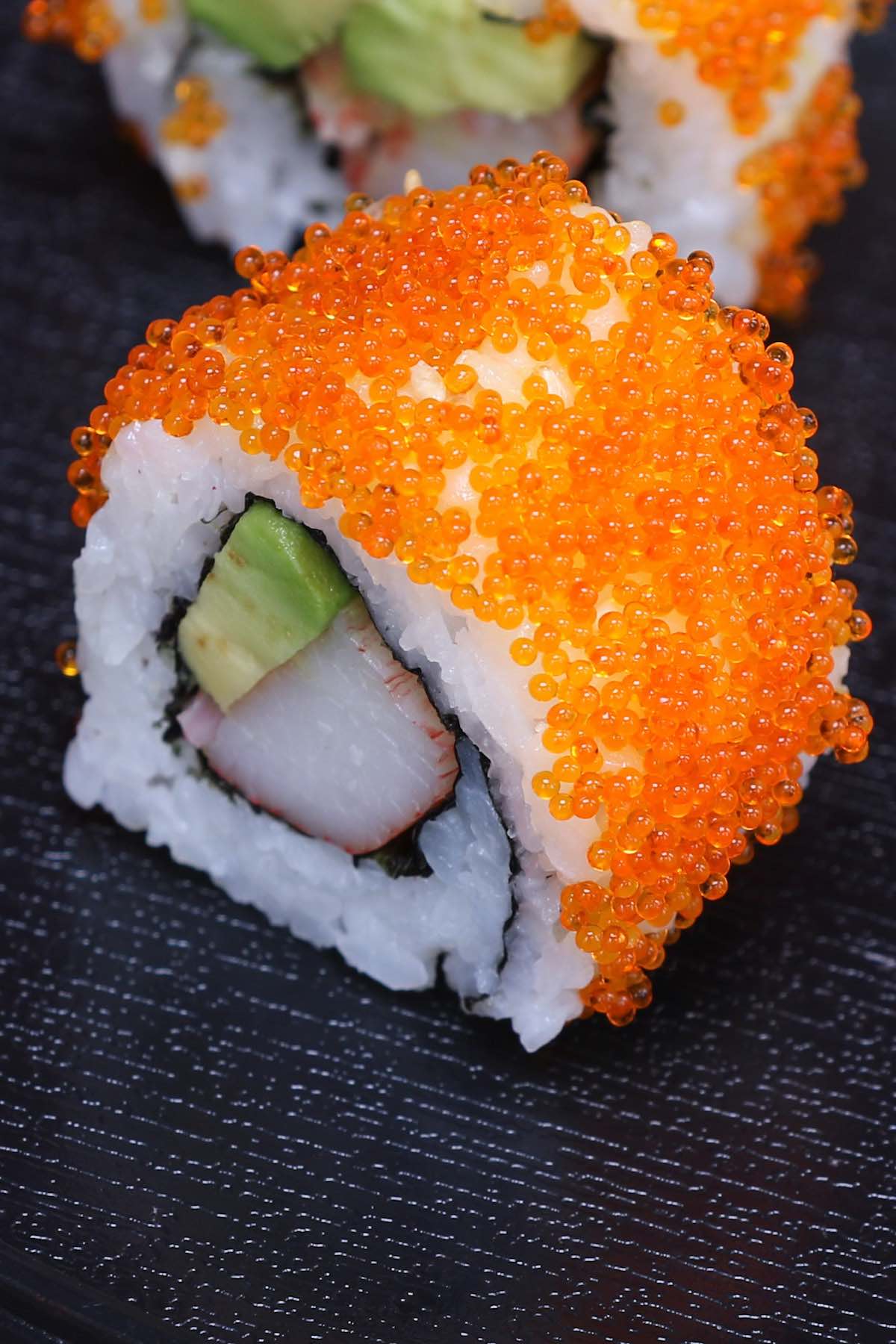 Masago is the roe of capelin, a fish in the smelt family. It’s a popular ingredient in Japanese cuisine because of its distinct taste. Masago eggs are very small, and often used as a topping in a variety of sushi recipes. In this post you’ll learn everything about masago and how to make masago sushi rolls. #masago #MasagoSushi