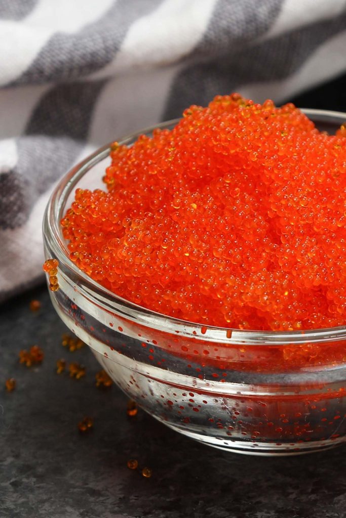 Masago is the roe of capelin, a fish in the smelt family. It’s a popular ingredient in Japanese cuisine because of its distinct taste. Masago eggs are very small, and often used as a topping in a variety of sushi recipes. In this post you’ll learn everything about masago and how to make masago sushi rolls. #masago #MasagoSushi