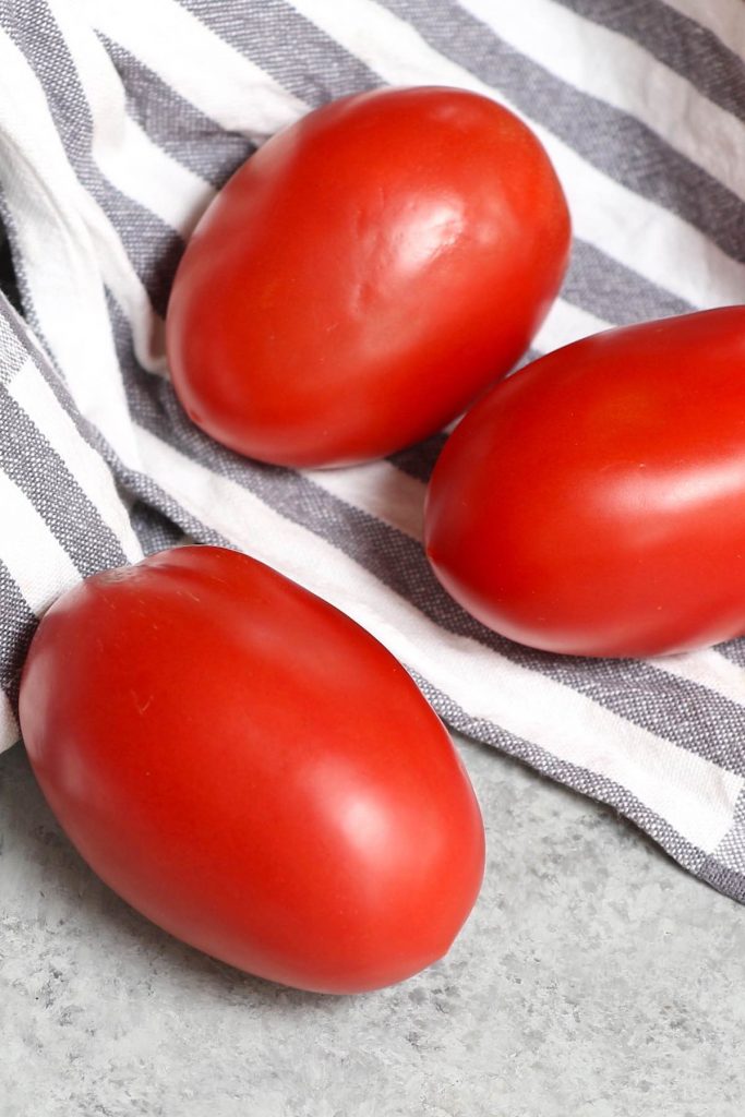 Plum tomatoes are colorful, egg-shaped tomatoes that are great for making thick tomato sauce and tomato paste due to its relatively low water content. So what are they exactly? How to use them? What are the sizes? How to make tomato sauce? Let’s find out everything about plum tomato in this post! #PlumTomatoes