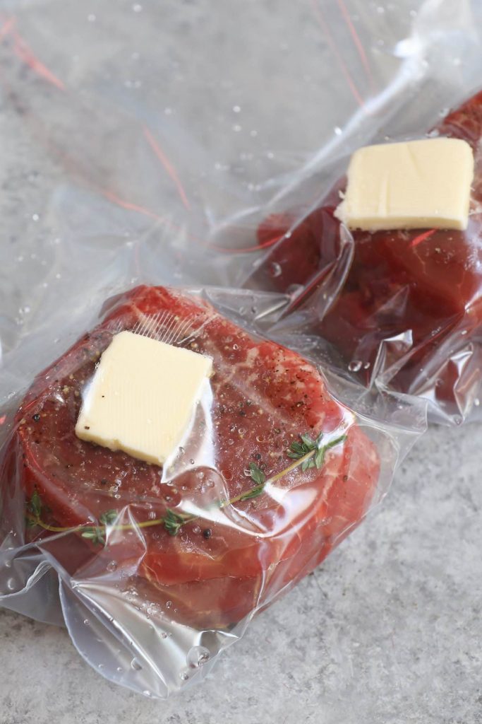 Vacuum-sealed filet mignon steaks in a ziptop bag.