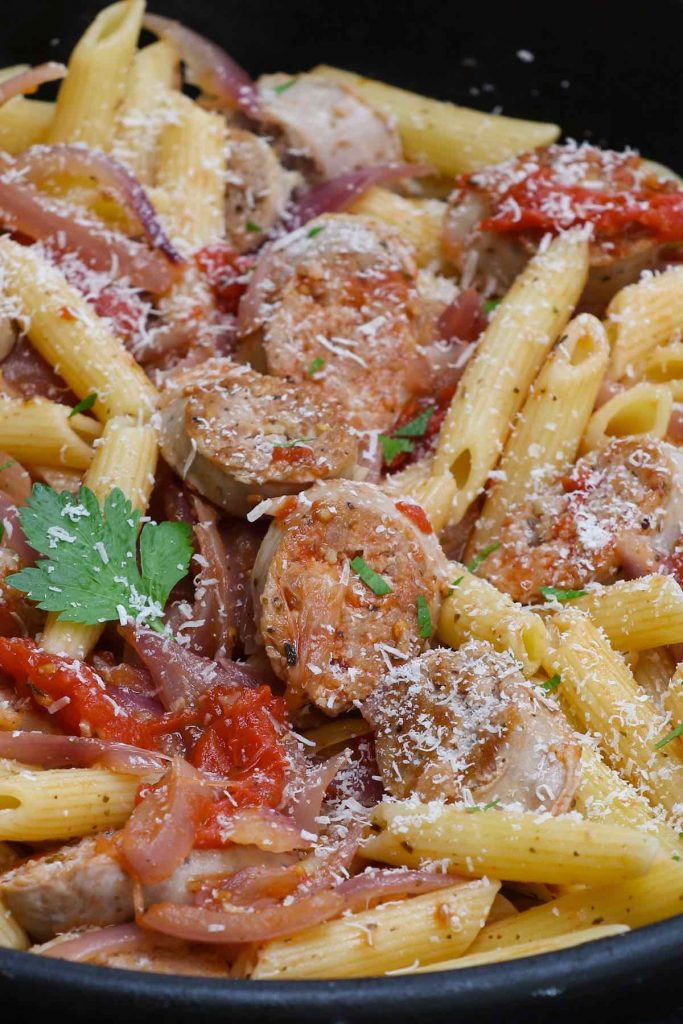 Sous vide Italian sausage and pasta sprinkled with grated Parmesan cheese.