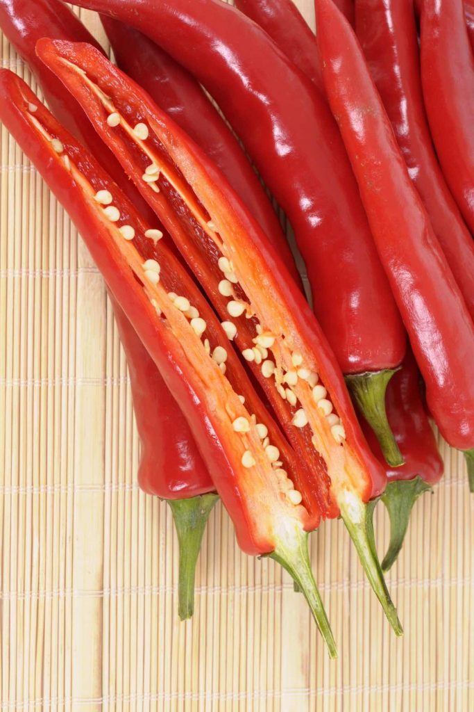 Thai peppers are spicy chili peppers that are used in many cuisines as a way to add heat to dishes. There are many types of Thai chili peppers: some are mild; others are extremely hot. Learn how to use them, different types, heat levels, substitute, and more! #ThaiPepper #ThaiChili #ThaiChiliPepper