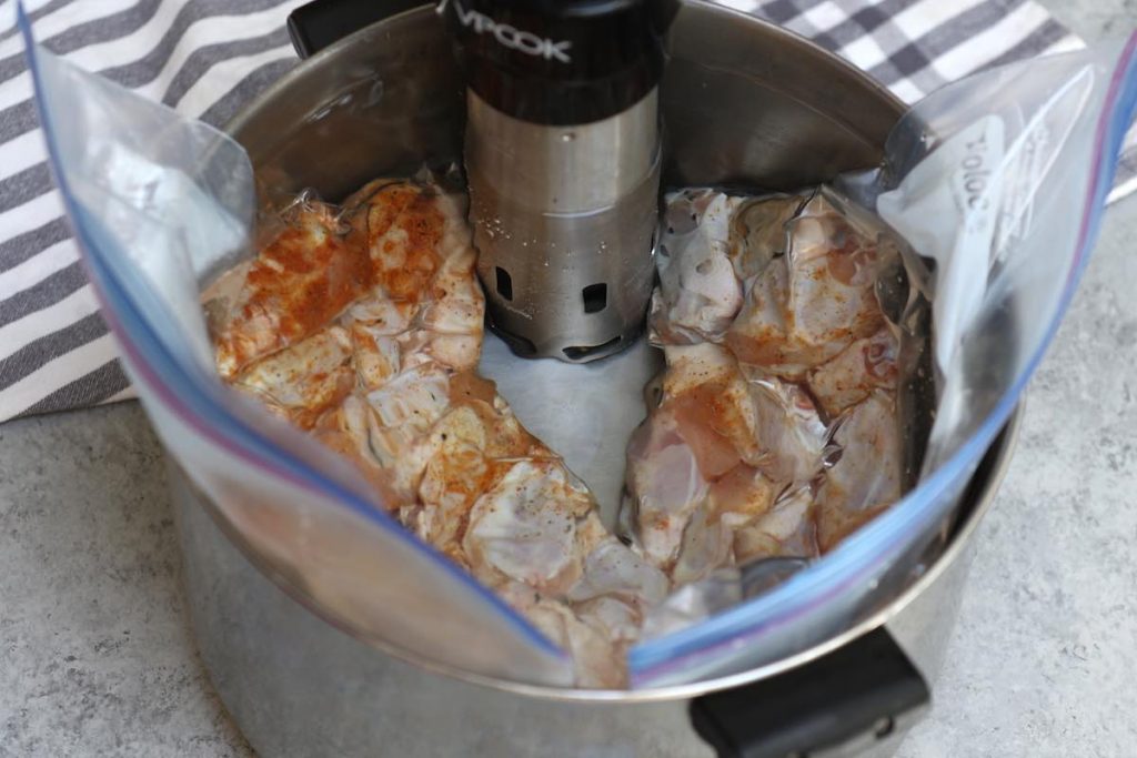 Sous vide cooking chicken wings in a water bath.