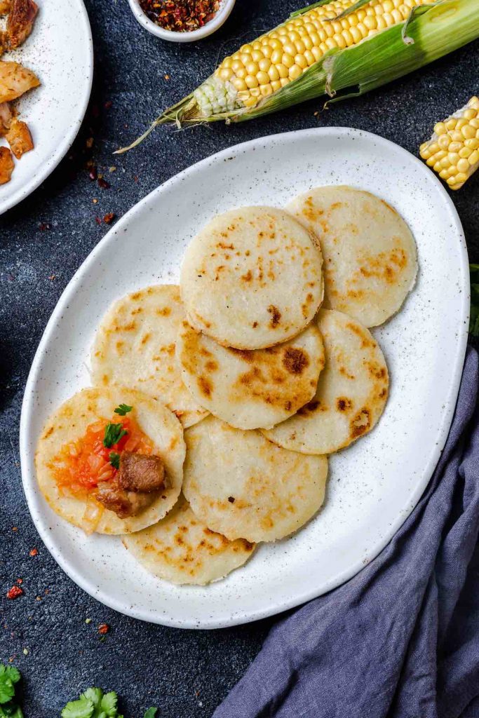 Homemade Arepa Paisa is so soft and fluffy – a delicious Colombian breakfast dish. It’s a popular flatbread made of corn, and can served on its own or topped with eggs, cheese or meat!