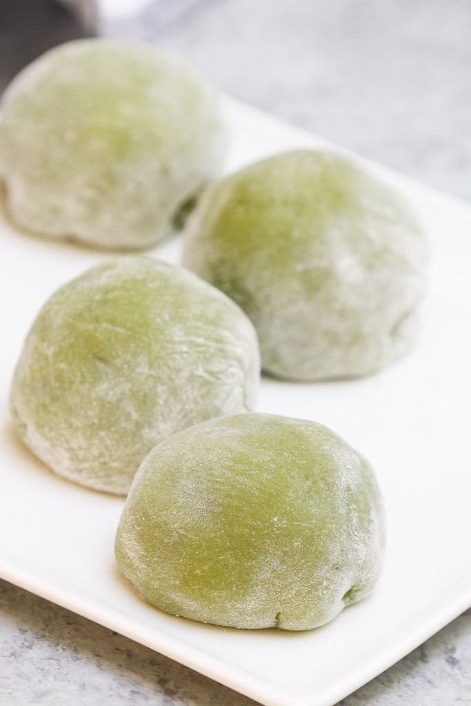 Homemade Green Tea Mochi is soft, chewy, and sweet with delicious matcha flavor and a beautiful green color. This classic Japanese treat is really easy to make at home and better than that from your favorite restaurant! Plus you can customize the filling with red bean paste, strawberry, or ice cream. #GreenTeaMochi #MatchaMochi