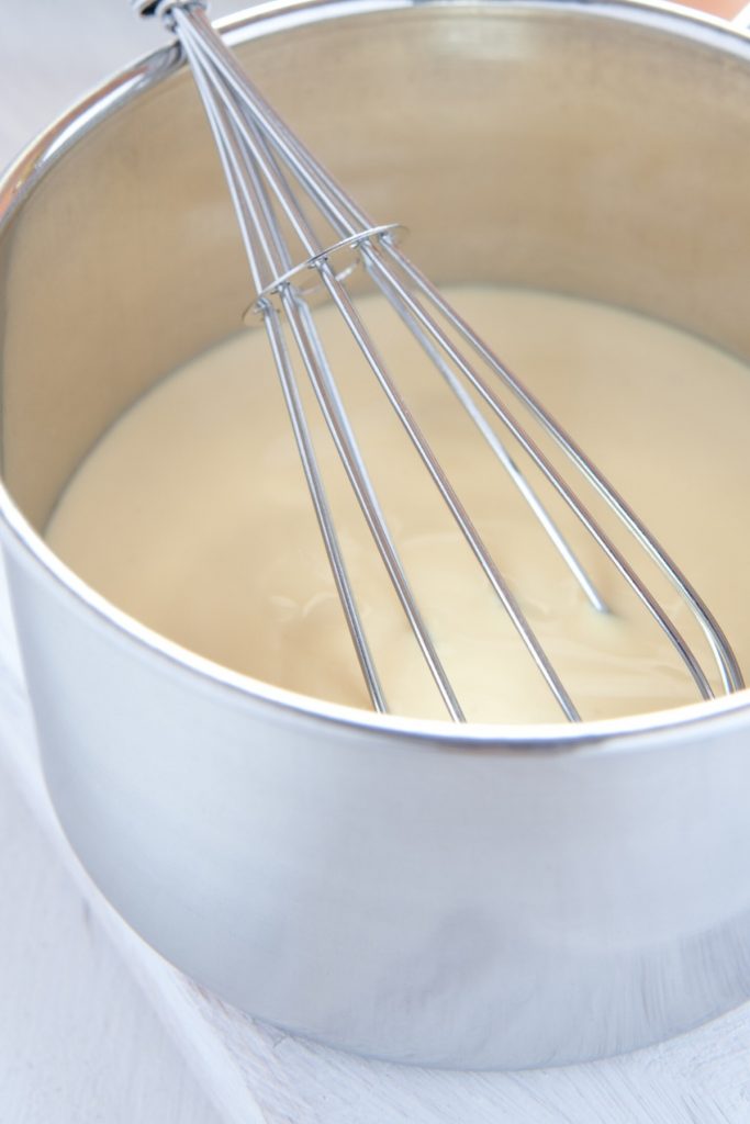 Whisking together the sauce ingredients in a sauce pan.