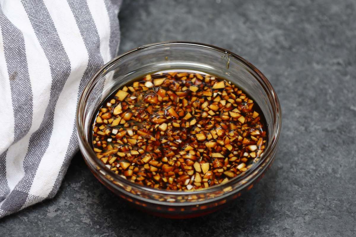 Honey garlic sauce in a clear bowl on the counter.