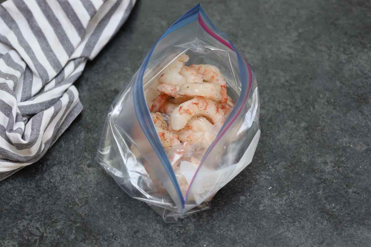 Add shrimp, oil, salt, and pepper in a zip-top bag.