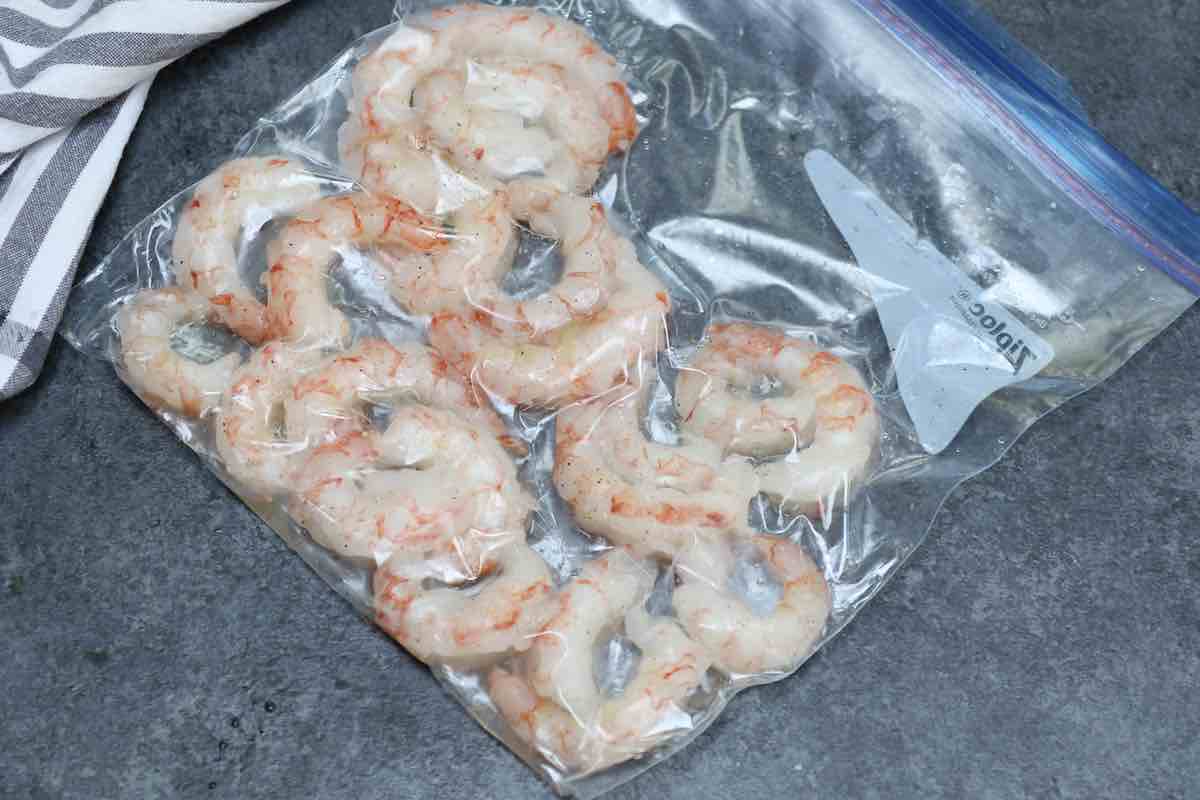 Seasoned shrimp vacuum sealed in a zip-top bag.