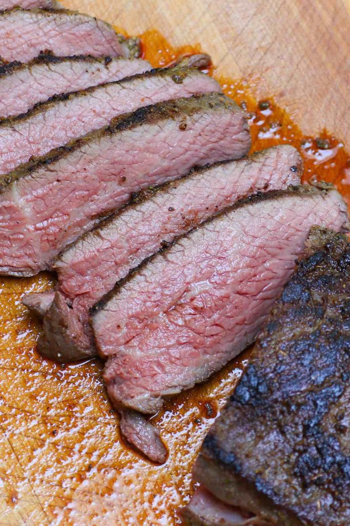 Santa Maria Style Sous Vide Tri Tip nails the edge-to-edge perfection on this triangle shaped bottom sirloin cut, resulting in amazingly juicy and tender steak. The tri-tip roast is cooked low and slow in a sous vide water bath, and then seared quickly in the skillet for a peppery, garlic-y brown crust. #SousVideTriTip #TriTipSouVide