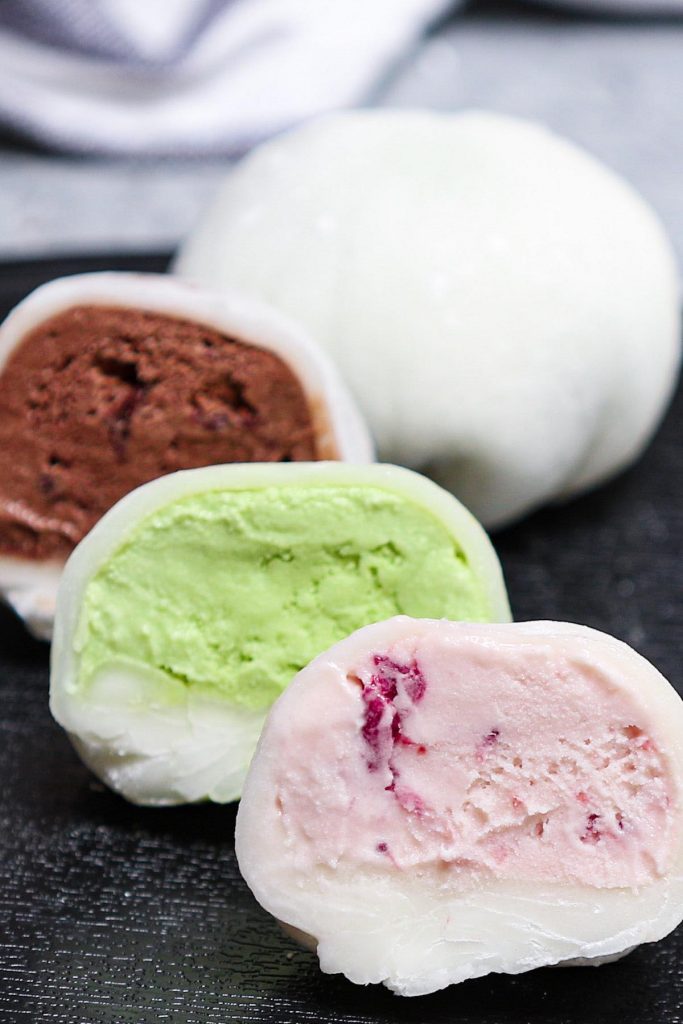 Mochi Ice Cream – sweet and creamy ice cream wrapped in smooth and pillowy mochi dough! It will float into your mouth and disappear! This easy Japanese dessert recipe makes a batch of the most delicious and dainty ice cream mochi balls with different flavors. Try strawberry, green tea matcha, or chocolate! #MochiIceCream #Mochi