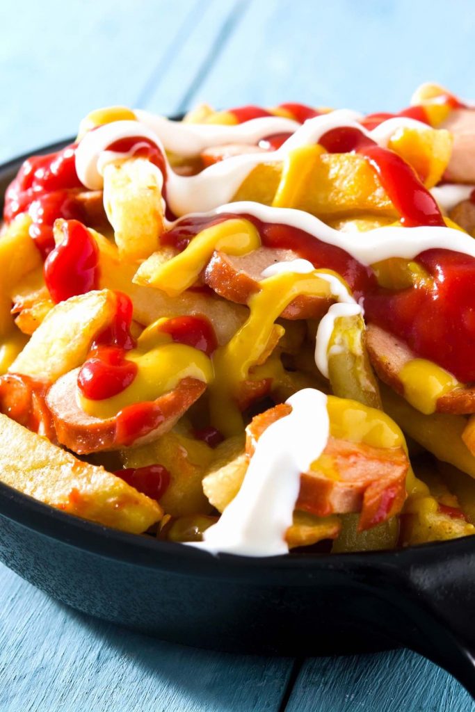 Salchipapas is a local Peruvian street food. But you can easily make it at home with homemade French fries and pan-fried hot dogs. This fast food is perfect for parties, game days, or other special occasions when you crave a tasty and comfort appetizer or meal. #Salchipapa #Salchipapas