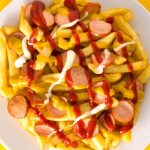 Salchipapas is local Peruvian street food. But you can easily make it at home with homemade French fries and pan-fried beef sausages. This fast food is perfect for parties, game days, or other special occasions when you crave a tasty and comfort appetizer or meal. #Salchipapa #Salchipapas