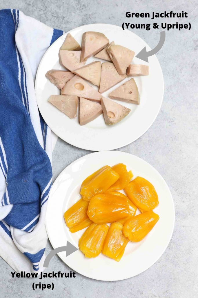 Young green jackfruit and yellow ripe jackfruit on two plates to show the contrasting colors and textures.