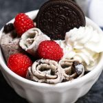 This homemade Rolled Ice Cream has the sweet and milky frozen dessert rolled up in a Thai ice cream style. Made with 2 basic ingredients plus mix-ins, and then topped with your favorite flavors like Oreos, whipped cream or raspberries.