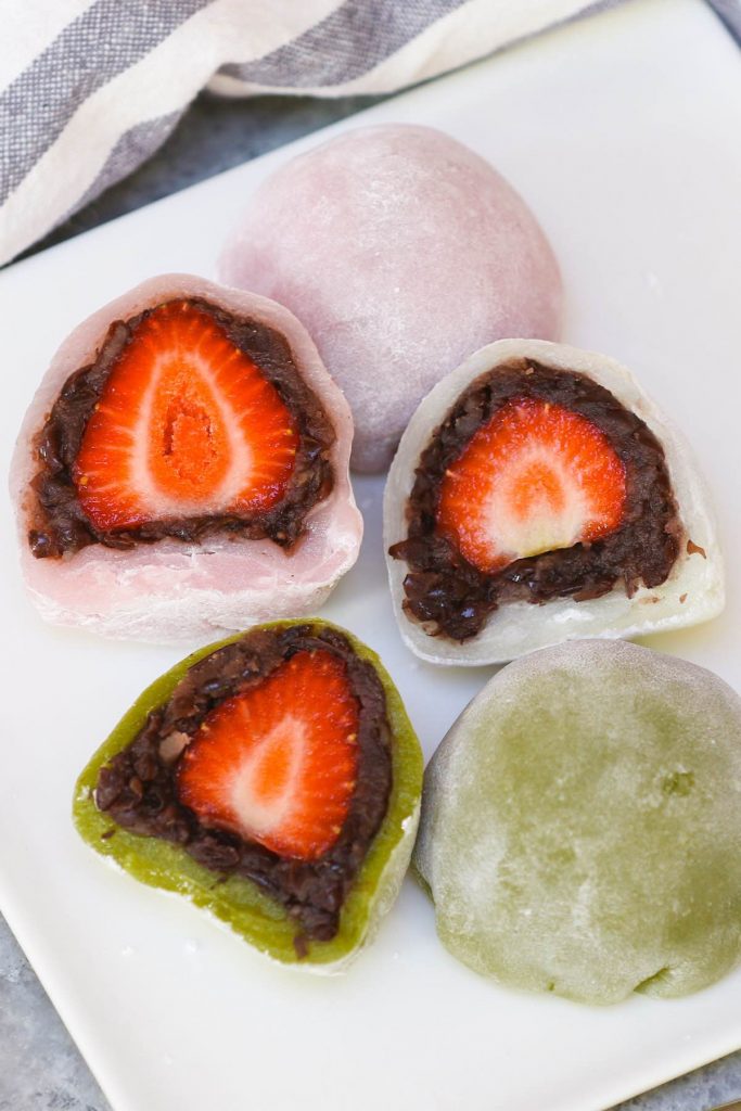 Looking for an indulgent and refreshing dessert recipe? Try Strawberry Mochi! The fresh, juicy strawberry and sweet red bean paste are covered with the chewy and soft mochi cake. This beautiful Japanese strawberry ichigo daifuku mochi is quick to make, and you can easily customize it for ice cream or red bean filled mochi balls! #StrawberryMochi #StrawberryDaifuku #IchigoDaifuku