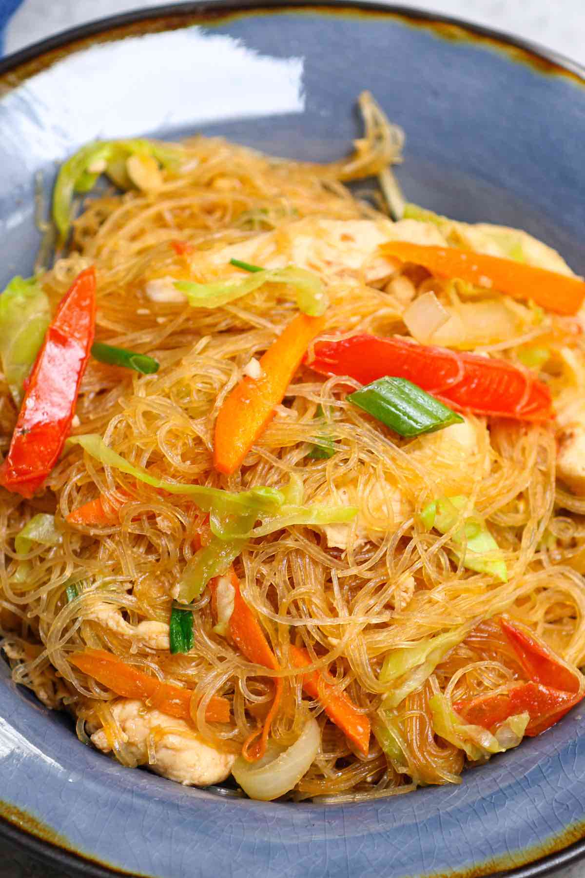 This amazing Pad Woon Sen recipe is surprisingly easy to make at home in under 30 minutes. It’s a Thai stir fried noodle dish made with glass noodles, proteins, veggies tossed in a savory and slightly sweet pad woon sen sauce.  It tastes like it came from your favorite Thai restaurant. #PadWoonSen #PadWoonSenRecipe #PadThaiWoonSen