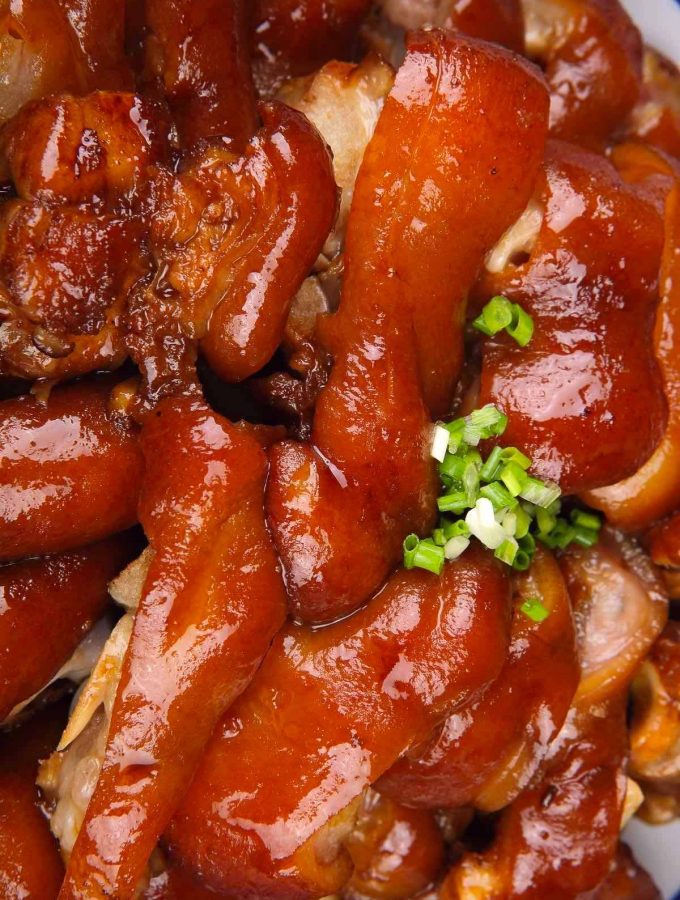 Braised Pig’s Feet are tender, juicy, and flavorful – cooked long and slow in a rich sauce. Pig feet or pig trotters are considered one of the most delicious parts of pork. My family makes this recipe for regular weekdays and special occasions like Chinese New Year. Serve them with mashed potatoes and green vegetables for an amazing meal! #PigFeet #PigFeetRecipe #PigTrotters #PorkFeet