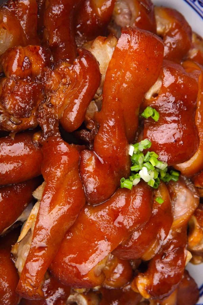 Braised Pig’s Feet are tender, juicy, and flavorful – cooked long and slow in a rich sauce. Pig feet or pig trotters are considered one of the most delicious parts of pork. My family makes this recipe for regular weekdays and special occasions like Chinese New Year. Serve them with mashed potatoes and green vegetables for an amazing meal! #PigFeet #PigFeetRecipe #PigTrotters #PorkFeet