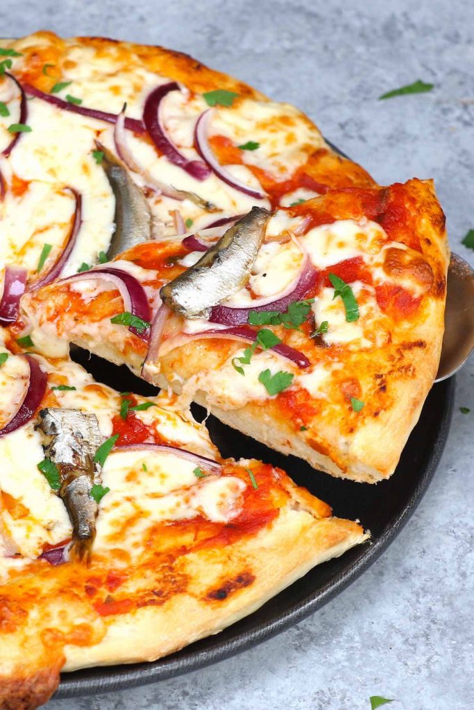 Sardine Pizza is my go-to meal when I have canned sardines and onions on hand. This classic Italian recipe is really easy and delicious. You’ll want to make this homemade pizza over and over again! #SardinePizza