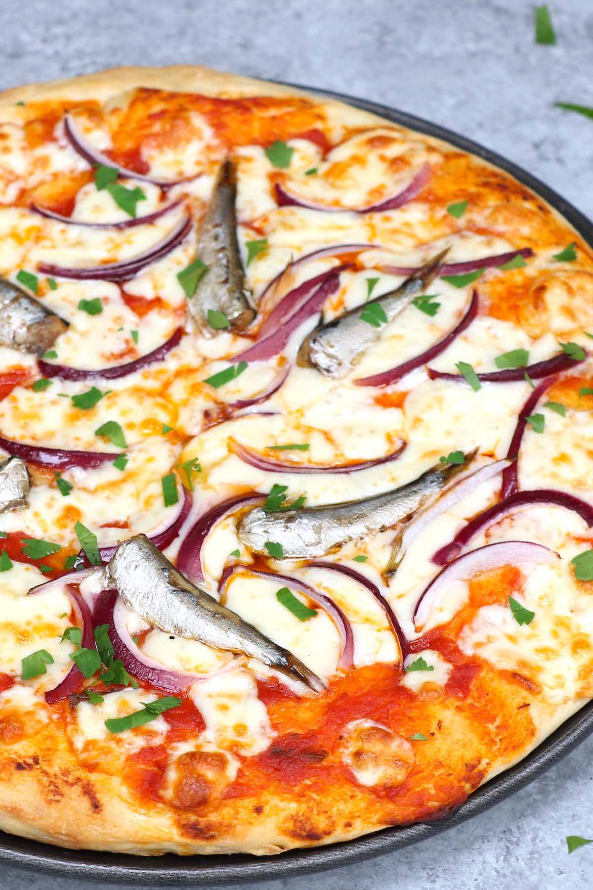 Sardine Pizza is my go-to meal when I have canned sardines and onions on hand. This classic Italian recipe is really easy and delicious. You’ll want to make this homemade pizza over and over again! #SardinePizza