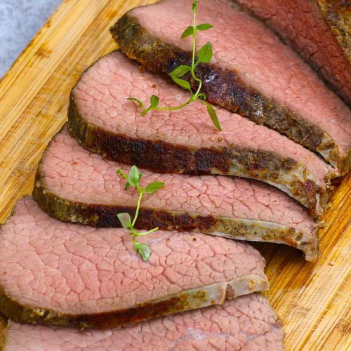 Sous Vide Eye of Round is the best way to cook this affordable beef cut, turning it into the most tender and juicy roast! This 16-hour low and slow sous vide method transforms the tough cut into a delicious eye of round roast that’s perfectly moist from edge to edge. Great for a festive holiday meal on a budget! #SousVideEyeOfRound