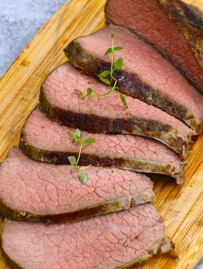 Sous Vide Eye of Round is the best way to cook this affordable beef cut, turning it into the most tender and juicy roast! This 16-hour low and slow sous vide method transforms the tough cut into a delicious eye of round roast that’s perfectly moist from edge to edge. Great for a festive holiday meal on a budget! #SousVideEyeOfRound