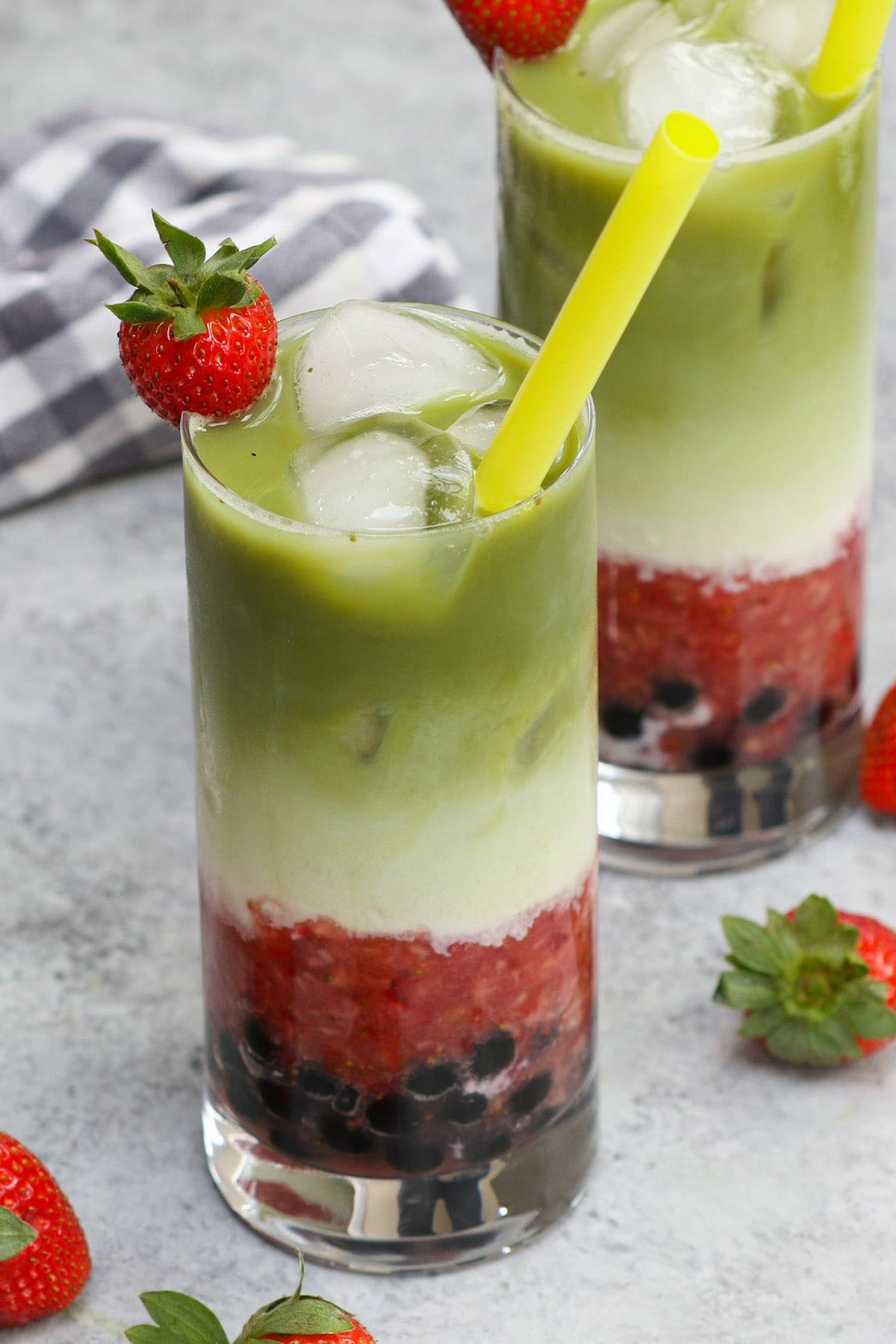 Ever wondered how to make Boba Guys’ insta-worthy layered Strawberry Matcha Latte? Here is an easy and simple bubble tea strawberry matcha latte recipe that shows how to make this creamy iced drink at home! It’s creamy, refreshing, and loaded with soft and chewy boba milk tea pearls. #StrawberryMatchaLatte #BobaStrawberryMatcha