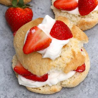 The easiest Bisquick Strawberry Shortcake made with original Bisquick pancake mix! Featuring fluffy Bisquick shortcakes layered with delicious strawberries and fresh whipped cream, these light and sweet biscuits are made with a few simple ingredients. A perfect summer dessert that’s sure to please everyone! #BisquickStrawberryShortCake #BisquickShortcake