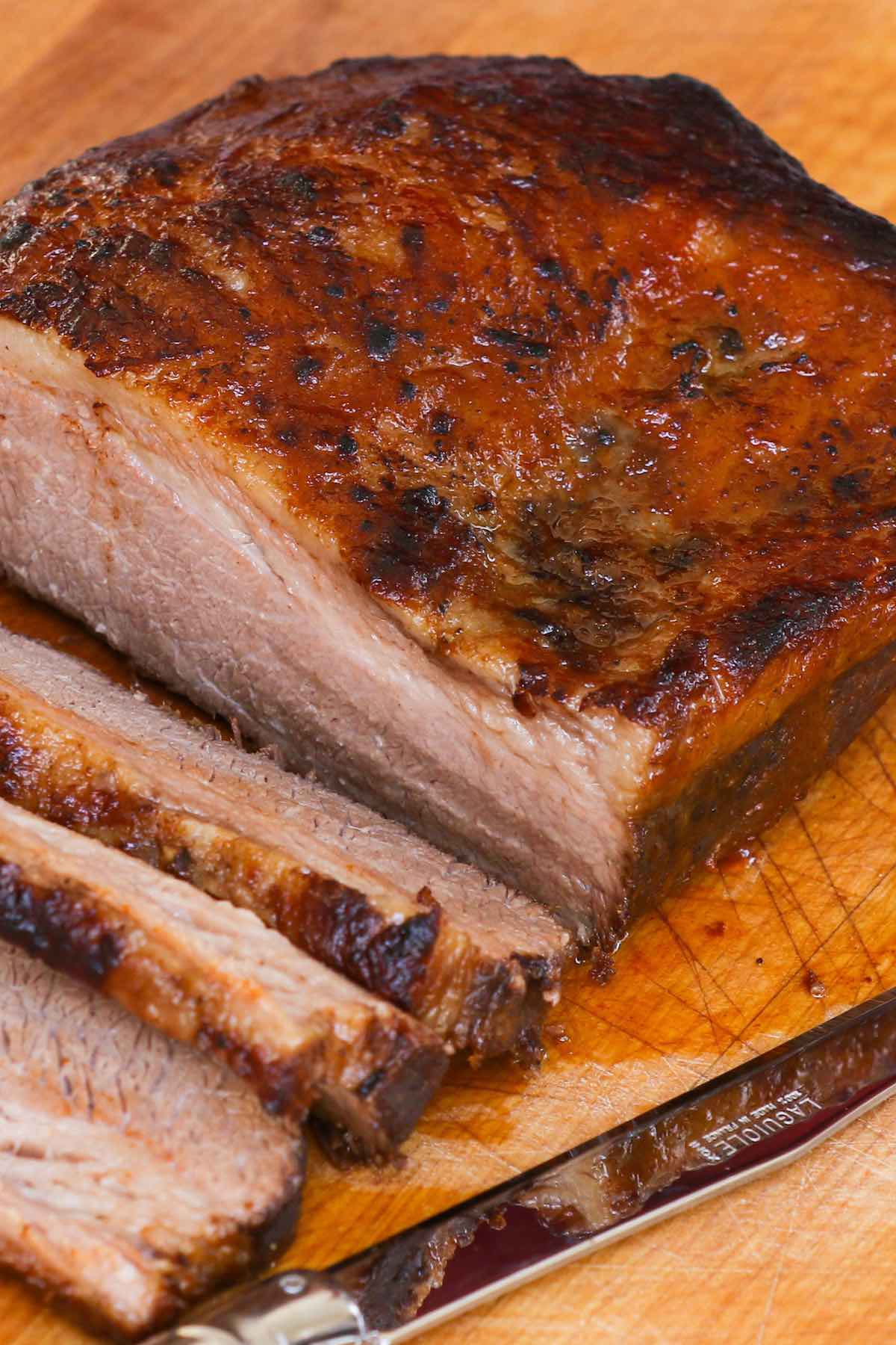 Perfectly cooked brisket served on a wooden cutting board.