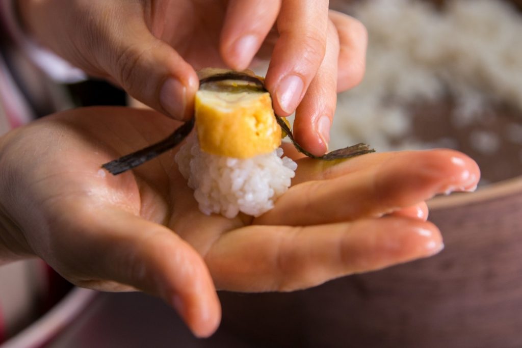 Showing assembling tamago sushi nigiri.