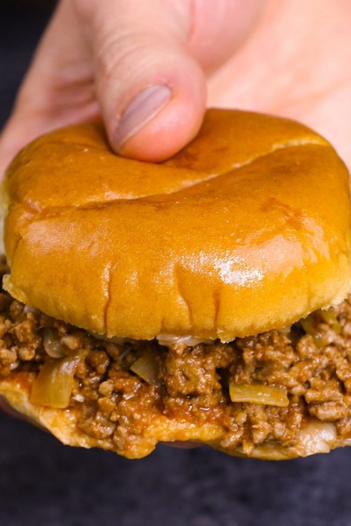 Closeup showing holding sloppy joes.