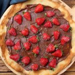 This Nutella Pizza is a must-try dessert that’s sure to impress your guest. It’s perfectly easy to make – this recipe skips out on the tomato and cheese in favor of adding chocolate spread onto the pizza crust, making a mouth-watering dessert.