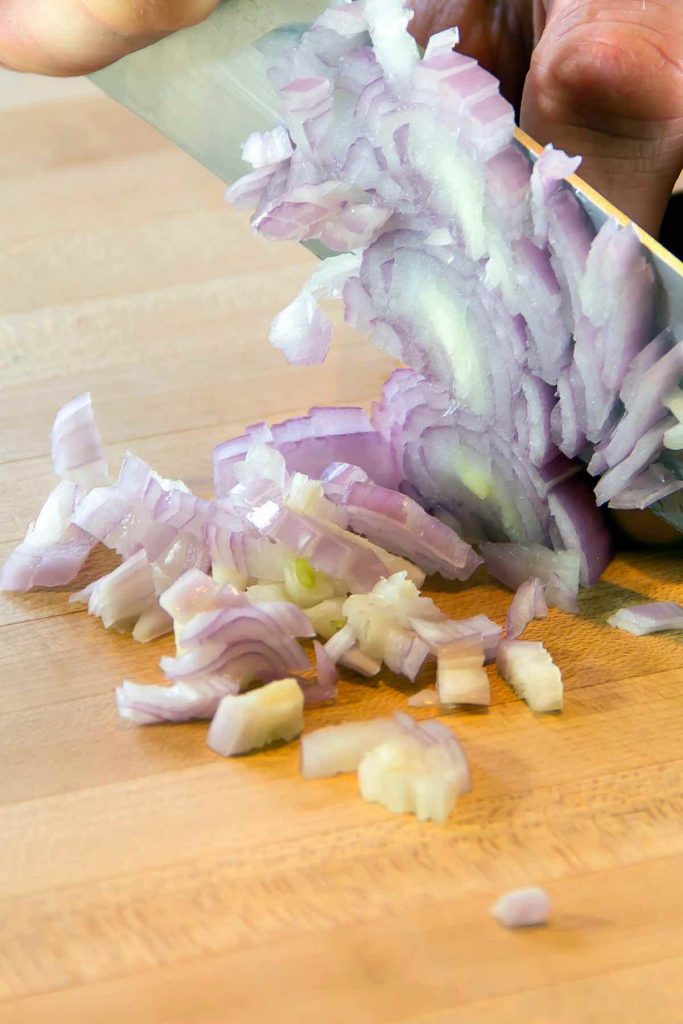 Cutting shallots into small pieces.