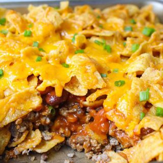 Take everything you love about a taco salad and turn it into a warm, cheesy, baked Walking Taco Casserole! The entire family will love this Tex-Mex recipe, with its succulent ground beef, gooey cheddar cheese and crunchy Fritos, Doritos, or Tortilla Chips. It’s easy to assemble ahead of time and bake later for a quick dinner!