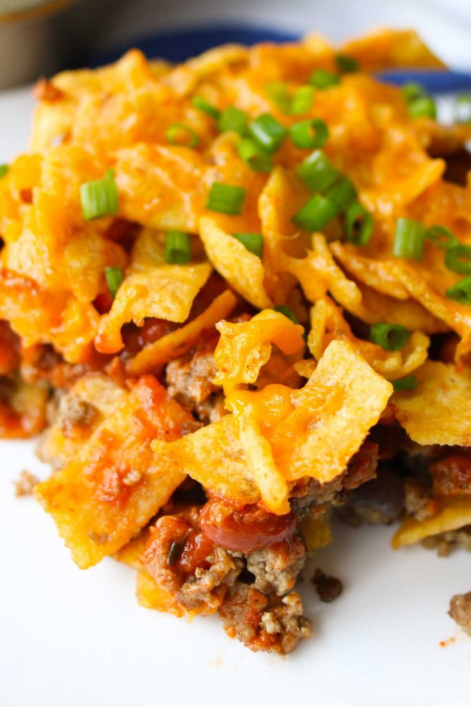 Take everything you love about a taco salad and turn it into a warm, cheesy, baked Walking Taco Casserole! The entire family will love this Tex-Mex recipe, with its succulent ground beef, gooey cheddar cheese and crunchy Fritos, Doritos, or Tortilla Chips. It’s easy to assemble ahead of time and bake later for a quick dinner!