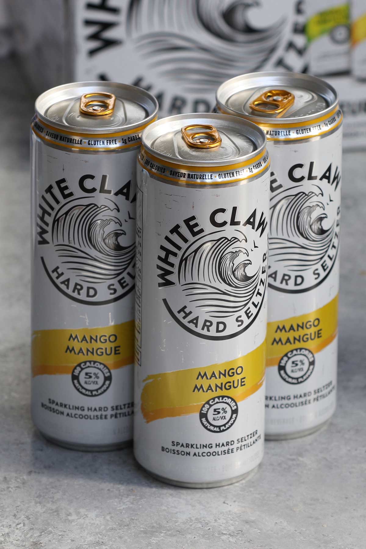 Closeup of mango flavoured white claw drinks.