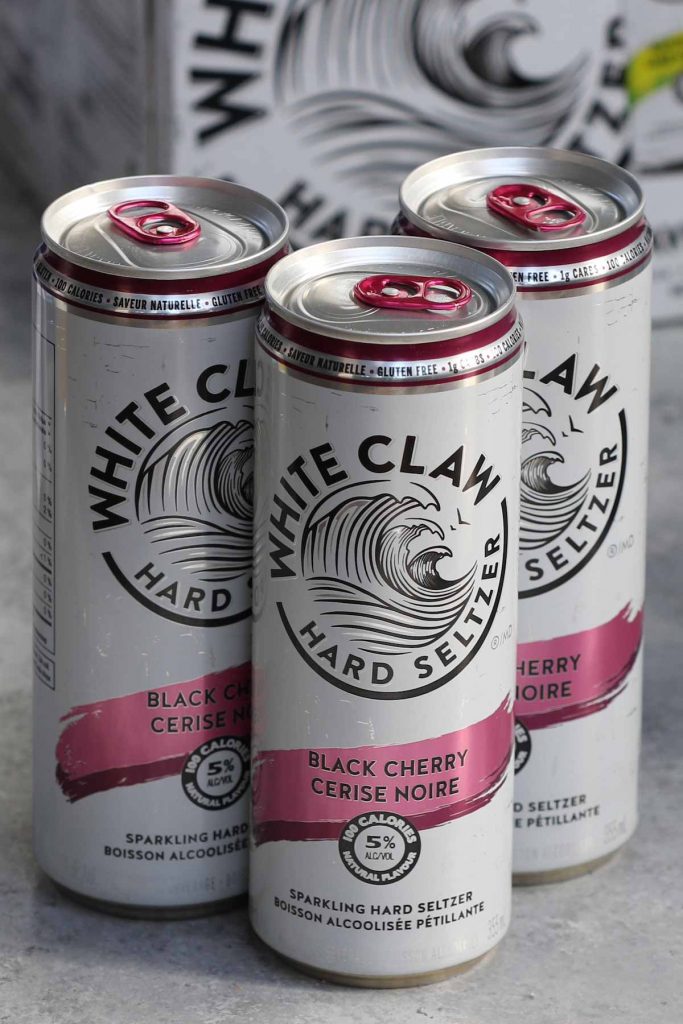 Photo showing 3 cans of black cherry white claw drinks.