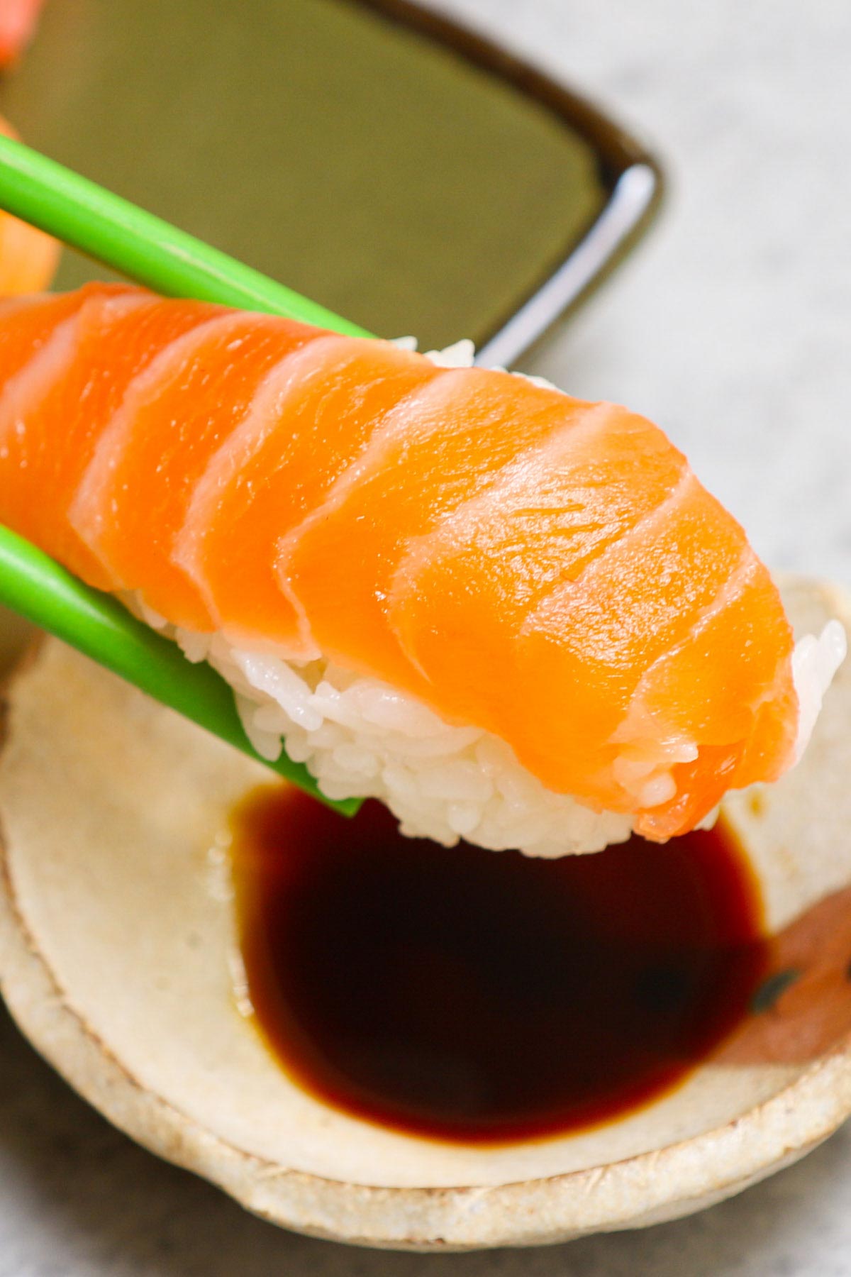 An easy and complete homemade Nigiri tutorial with lots of tips and tricks. Unlike maki sushi, nigiri isn’t rolled. Instead, it’s comprised of a thin slice of raw or cooked seafood like salmon or shrimp atop a mound of vinegary rice. You’ll learn everything about Japanese nigiri including the difference between nigiri and sashimi, and how to make perfect nigiri at home
