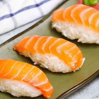 An easy and complete homemade Nigiri tutorial with lots of tips and tricks. Unlike maki sushi, nigiri isn’t rolled. Instead, it’s comprised of a thin slice of raw or cooked seafood like salmon or shrimp atop a mound of vinegary rice. You’ll learn everything about Japanese nigiri including the difference between nigiri and sashimi, and how to make perfect nigiri at home.