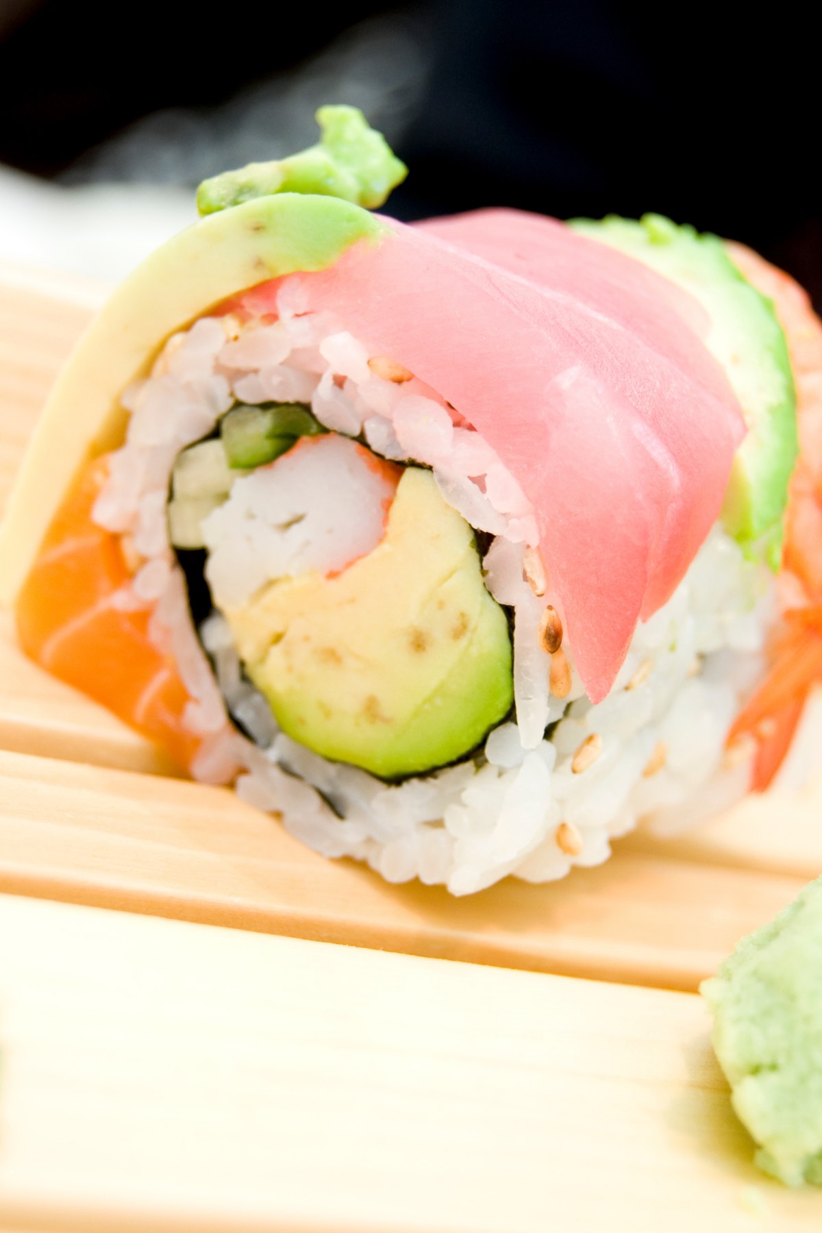  The Rainbow Roll is one of the most popular sushi items at many Japanese restaurants. It’s uramaki sushi with the rice on the outside, covering seaweed nori, and filled with creamy avocado and imitation crab. Atop the rainbow sushi roll is a colorful assortment of fresh fish such as salmon, tuna, yellowtail, together with slices of avocado. This roll is a great way to sample many types of fish at once. 